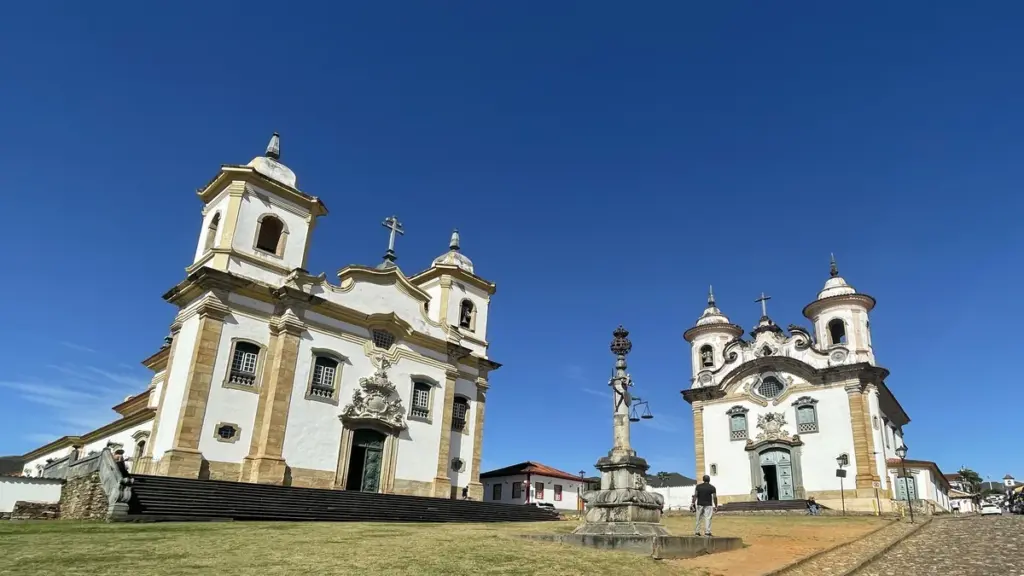 Igrejas de São Francisco de Assis e Nossa Senhora do Carmo na Praça Minas Gerais, em Mariana, com o pelourinho entre elas